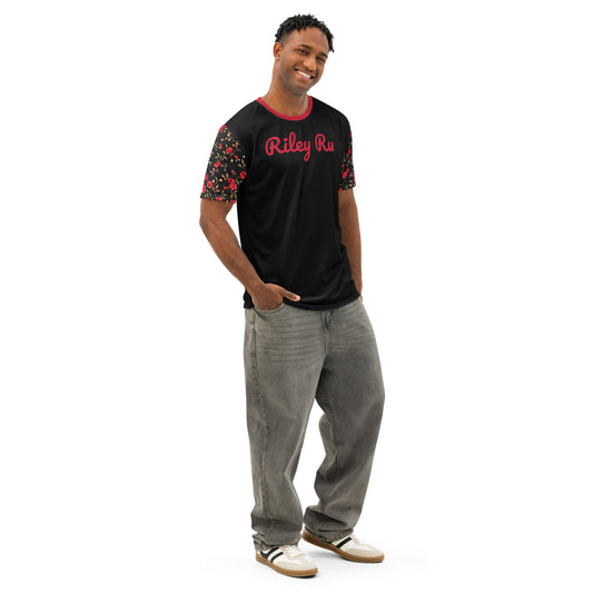 Man wearing a black t-shirt with red text and floral sleeves, standing against a white background