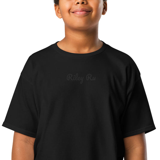 Person wearing a black t-shirt with 'Riley Ru' text on a white background