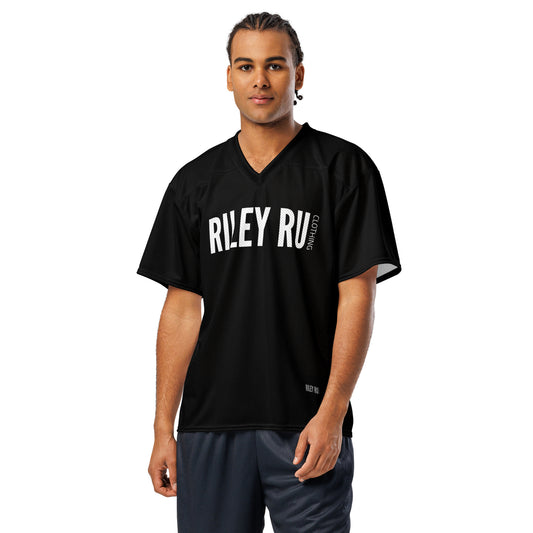 Man wearing a black sports jersey with 'RILEY RU' branding on a white background