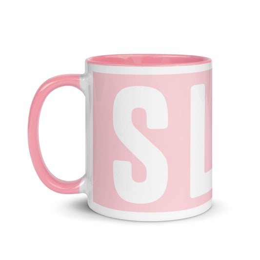Pink mug with white interior and 'SL' initials on a white background