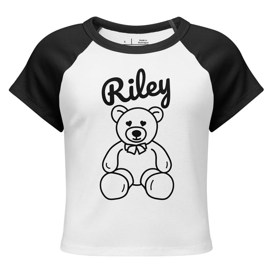 White and black baseball shirt with a teddy bear graphic and 'Riley' text on a white background